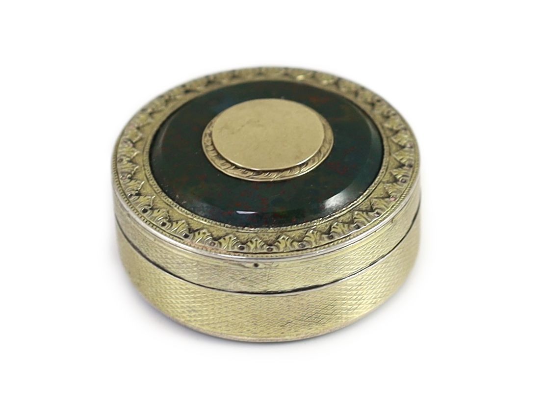 A George III engine turned silver gilt and inset bloodstone circular snuff box and cover, maker's mark rubbed